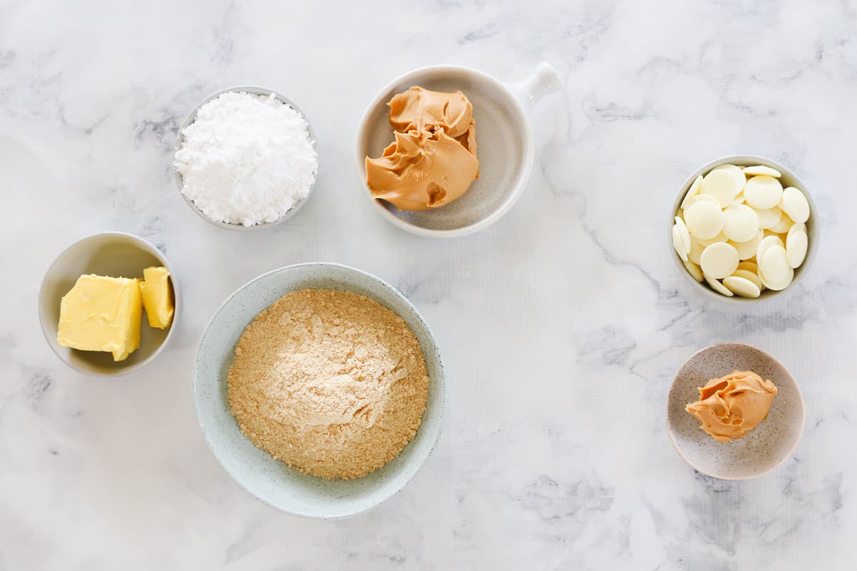 The ingredients for peanut butter slice in individual bowls.