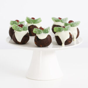 A cake stand of pudding balls with Christmas decorations.