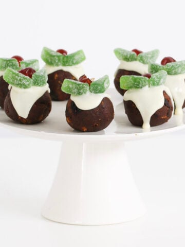 A cake stand of pudding balls with Christmas decorations.