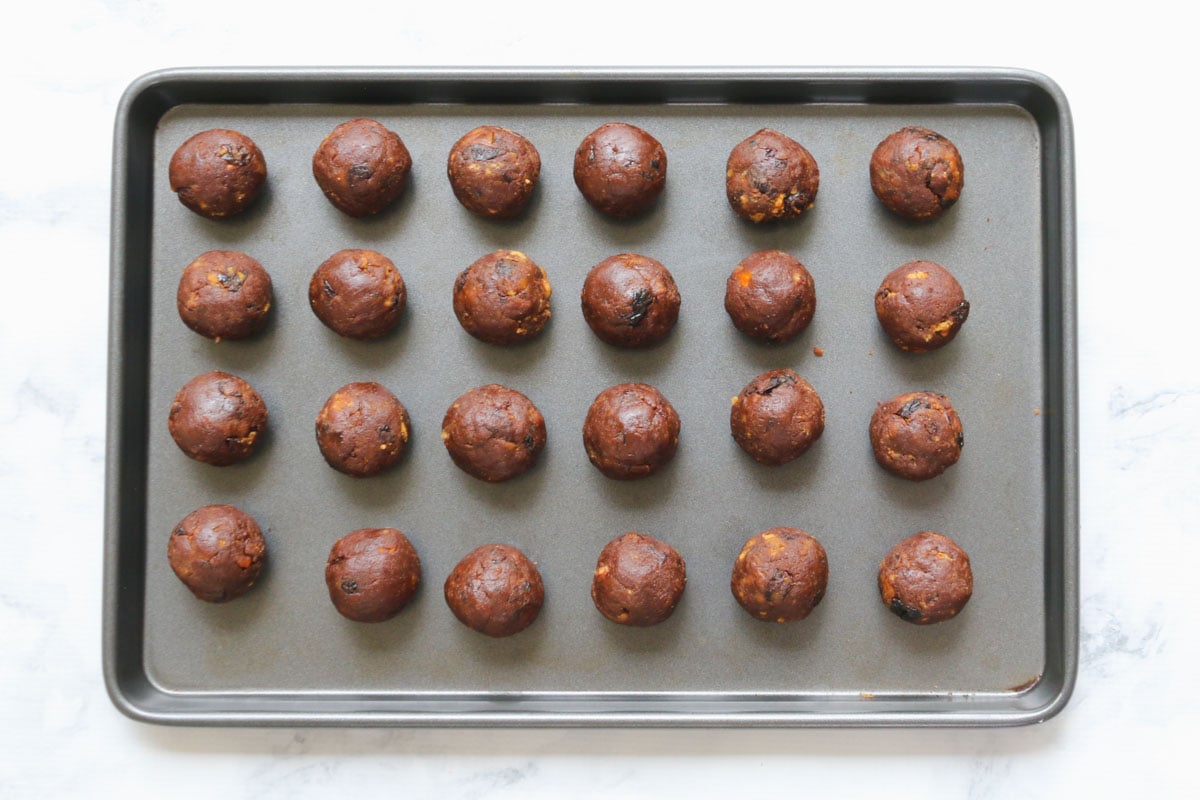 Mini round dessert balls on a baking tray.