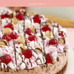 A Pinterest image with the text Rocky Road Cheesecake iabove an image of a chocolate cheesecake with marshmallows, nuts, lollies and coconut.