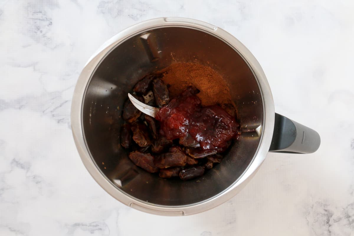 Dates, cocoa and jam in a food processor.