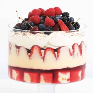 A layered strawberry trifle in a glass dish.