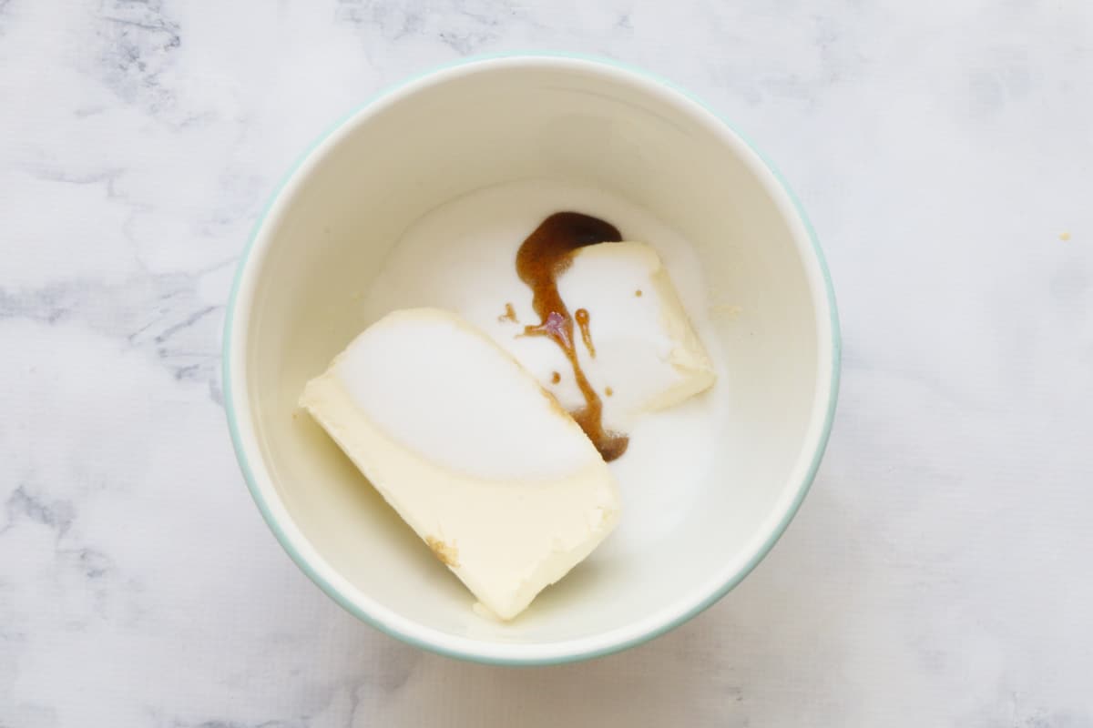 Cream cheese, sugar and vanilla in a bowl.