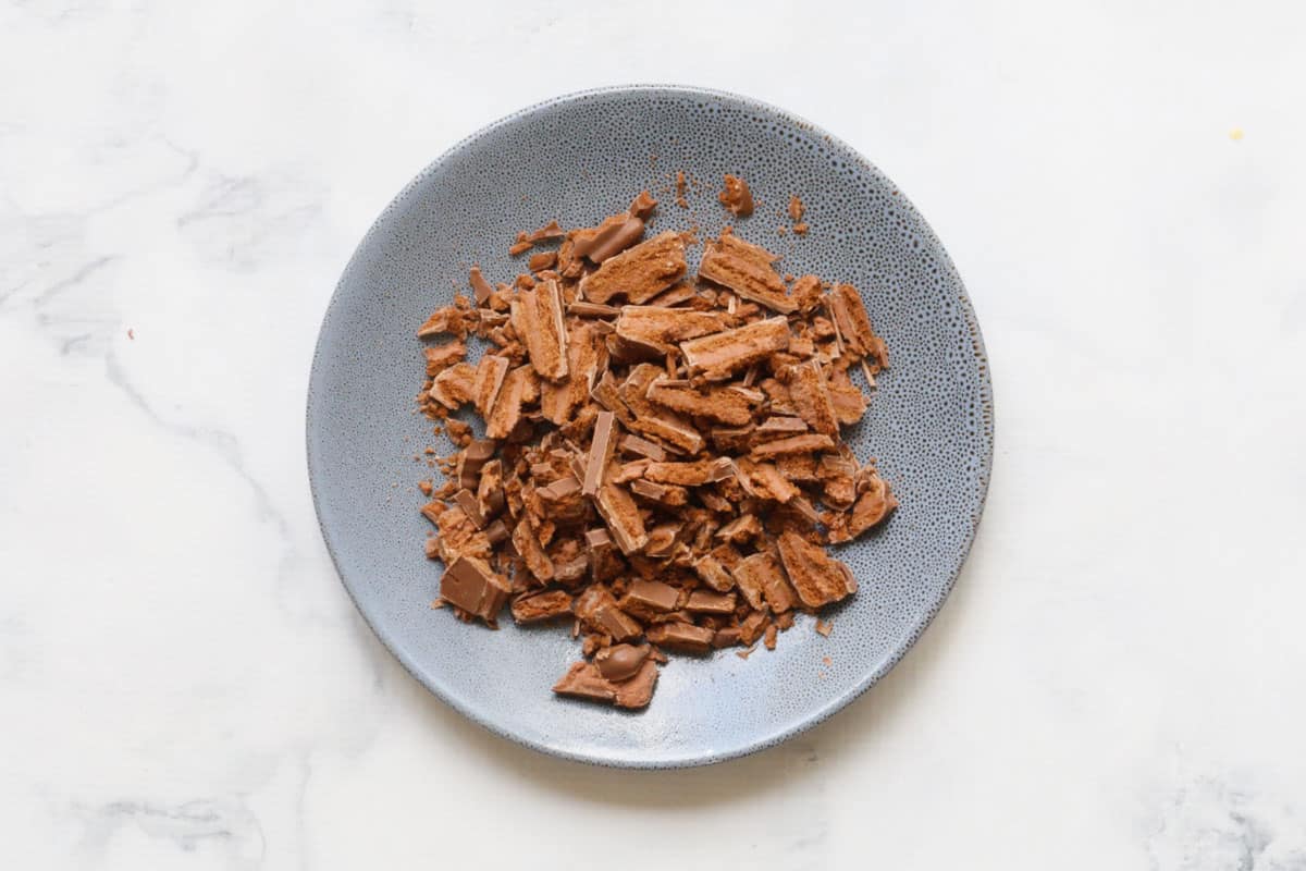 Chopped Tim Tam biscuits on a plate.