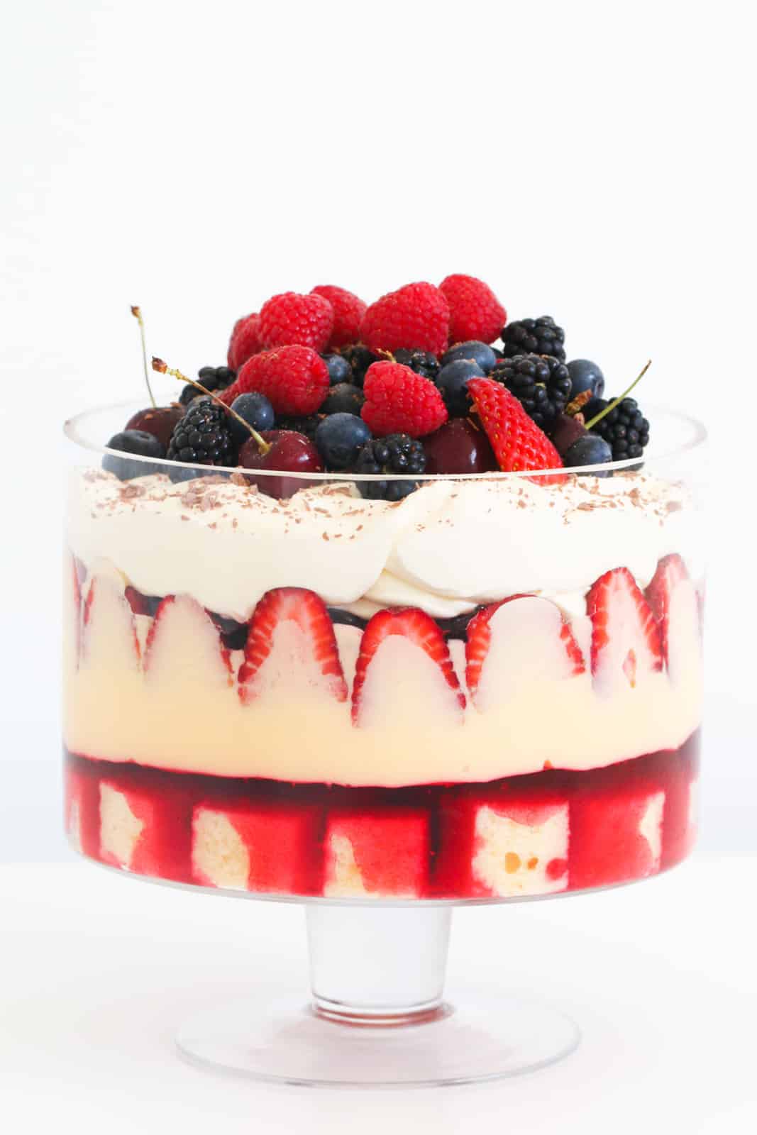 A layered strawberry trifle in a glass dish.