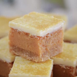 A stack of golden caramel filled squares with white chocolate topping