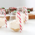 Christmas themed desserts, with individual cheesecakes and a blurred slice in the background