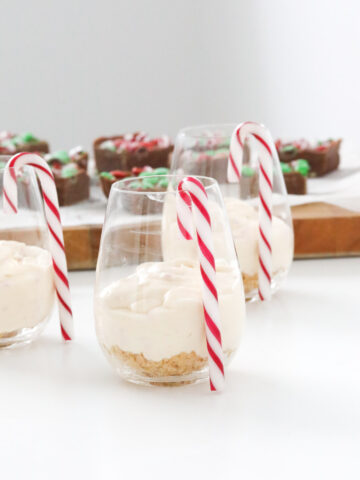 Christmas themed desserts, with individual cheesecakes and a blurred slice in the background