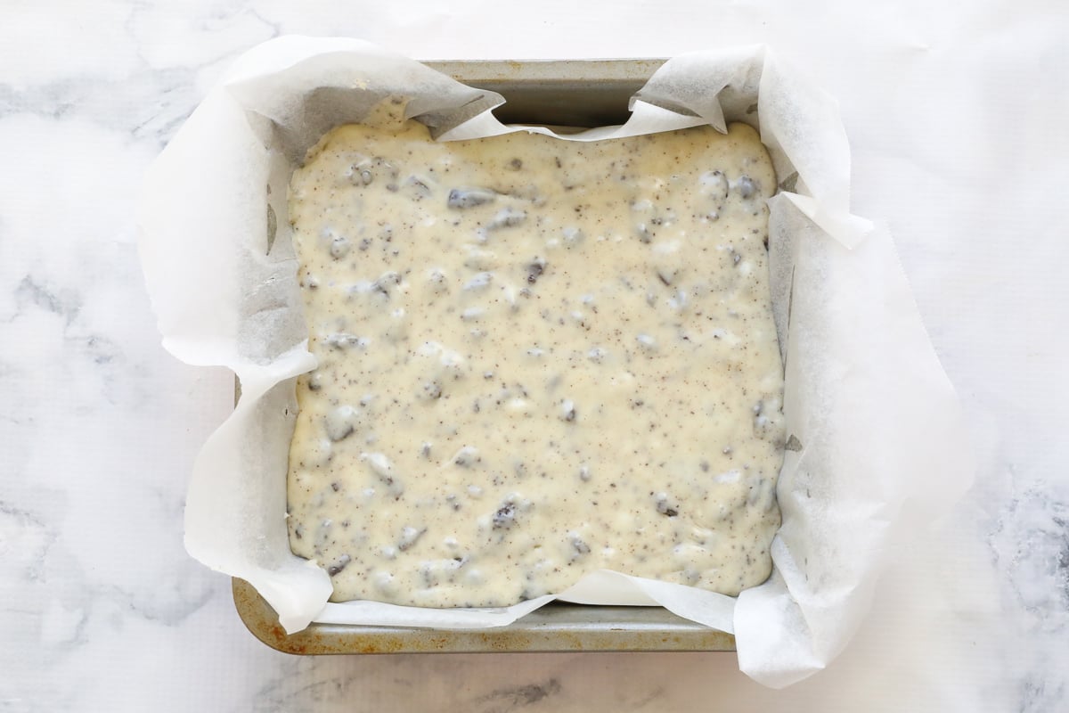 A lined baking tin of white chocolate and Oreo fudge.