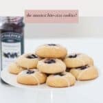 A batch of Thumbprint cookies filled with blueberry jam and drizzled with lemon icing.