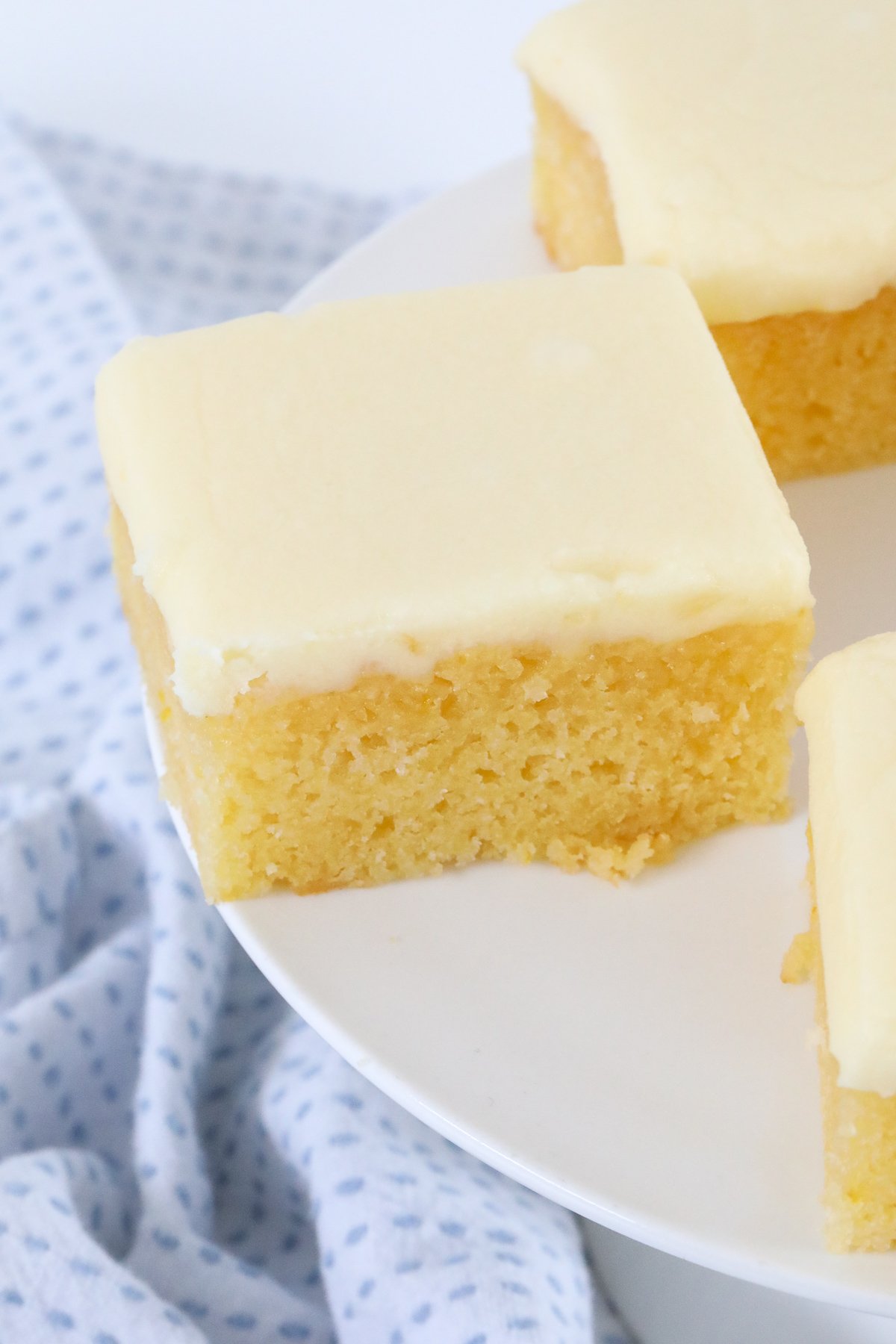 A close up of baked slice with lemon frosting on top