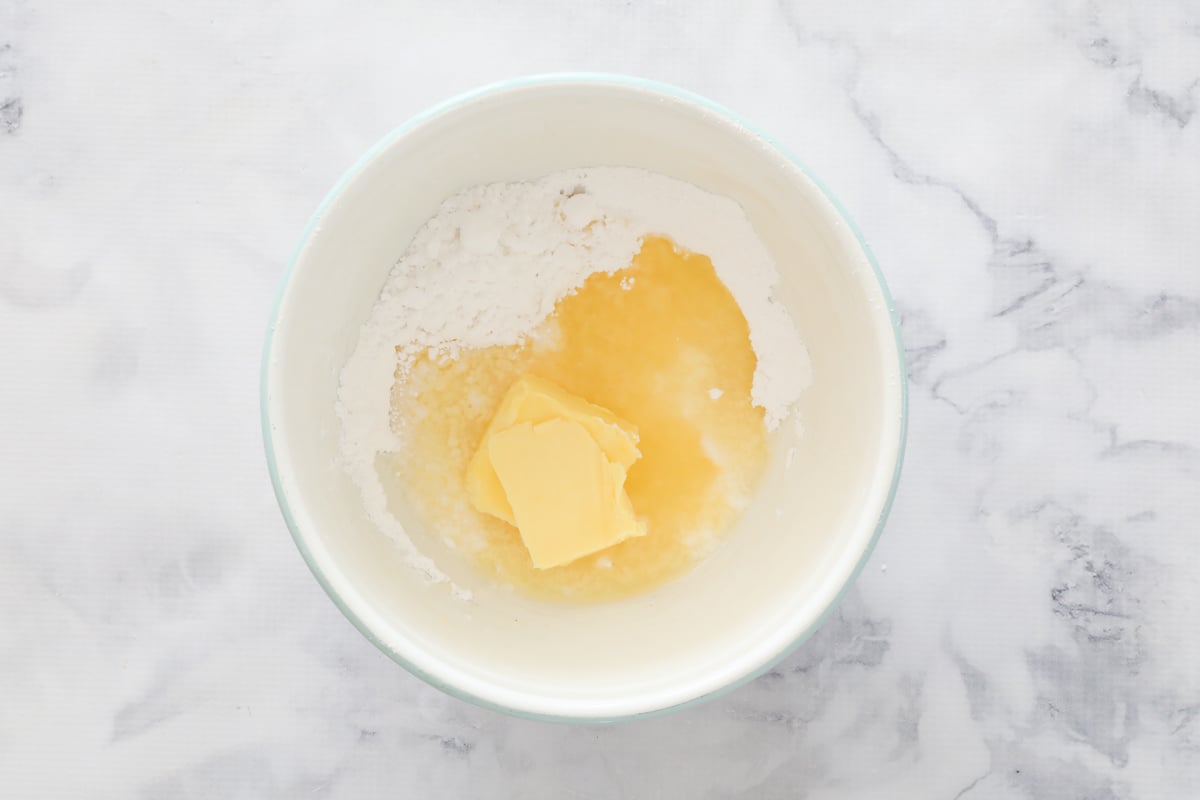 Icing sugar, butter and lemon juice in a bowl
