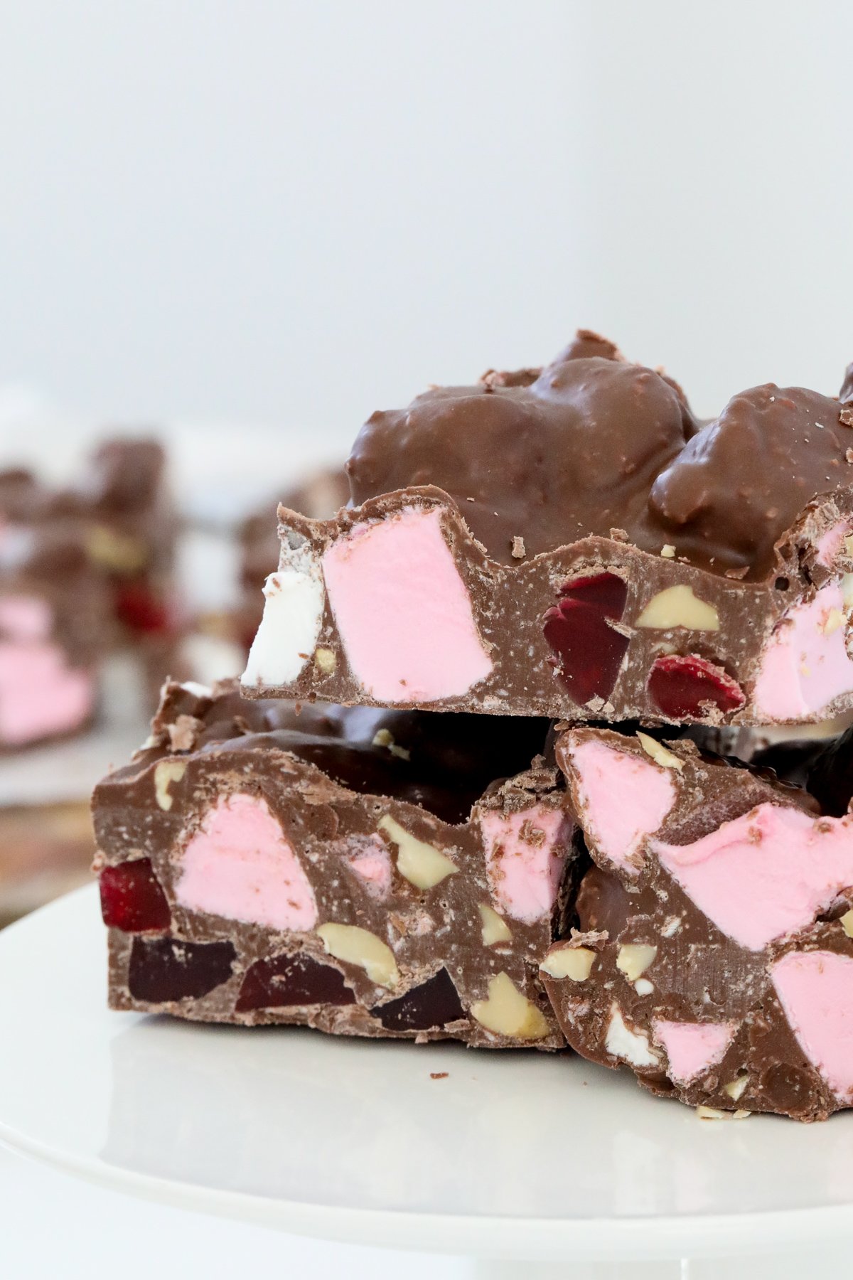 Pieces of chocolate rocky road on a cake stand.