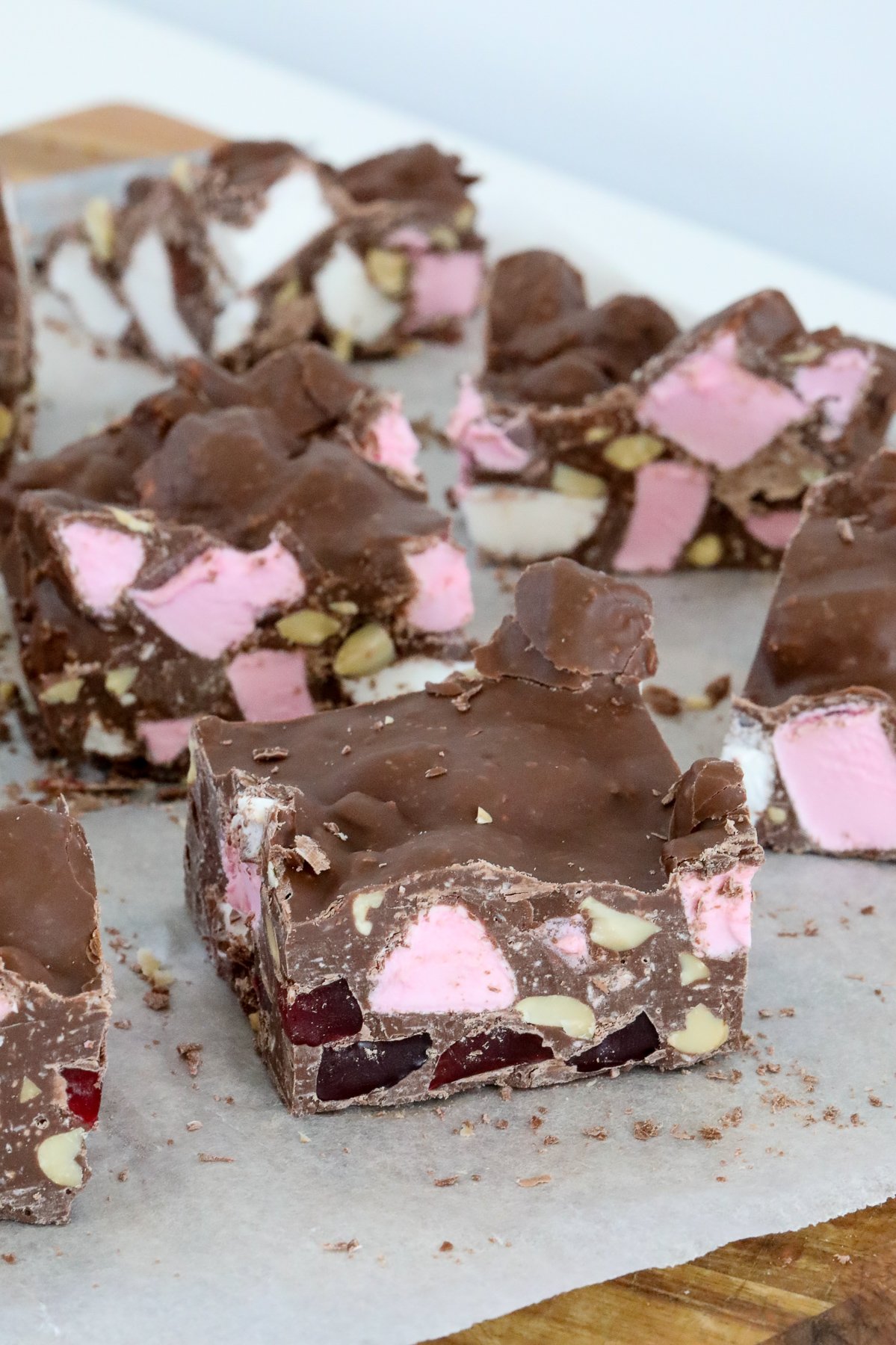 A piece of chocolate slice with marshmallows and nuts.