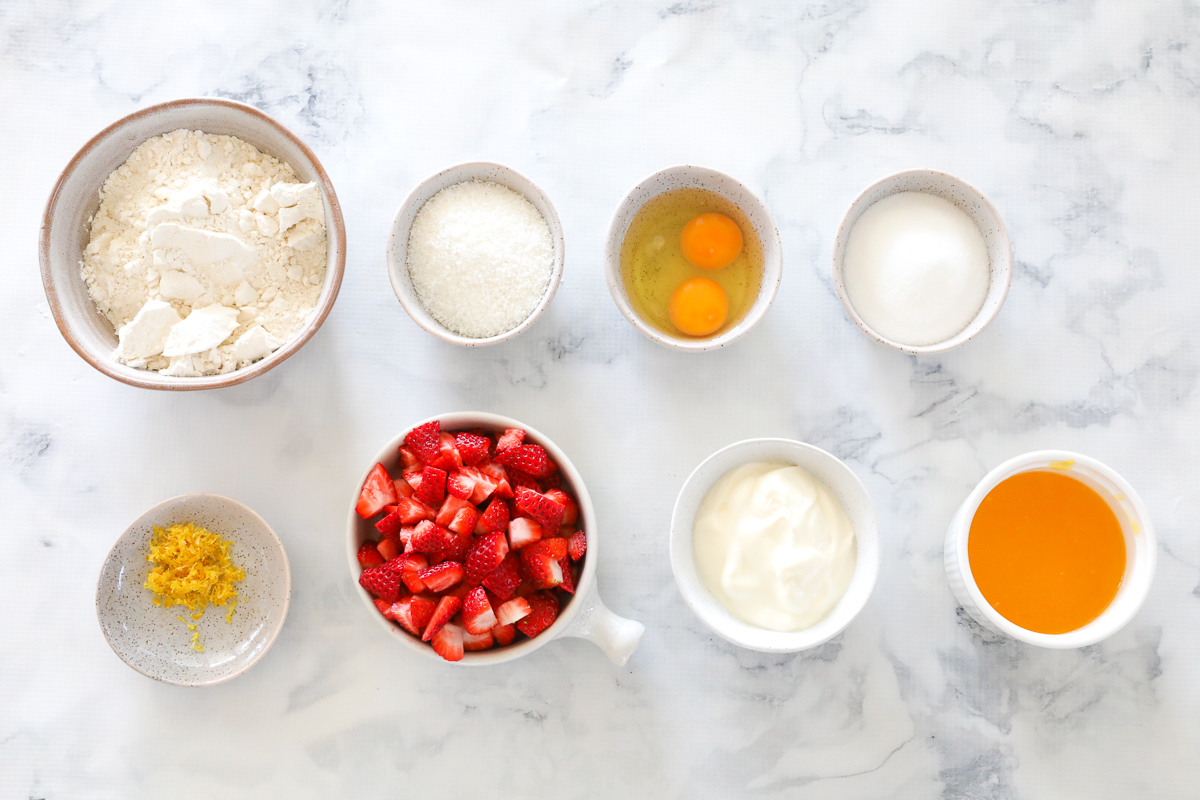 The ingredients for strawberry yoghurt loaf in individual bowls