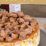 A no-bake cheesecake covered in chopped Mars bars and drizzled with caramel sauce