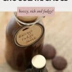 Looking down at a small bottle of Baileys chocolate sauce, with a label tied around it.