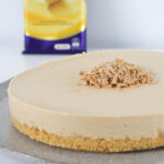 A Caramilk cheesecake with a block of chocolate in the background.