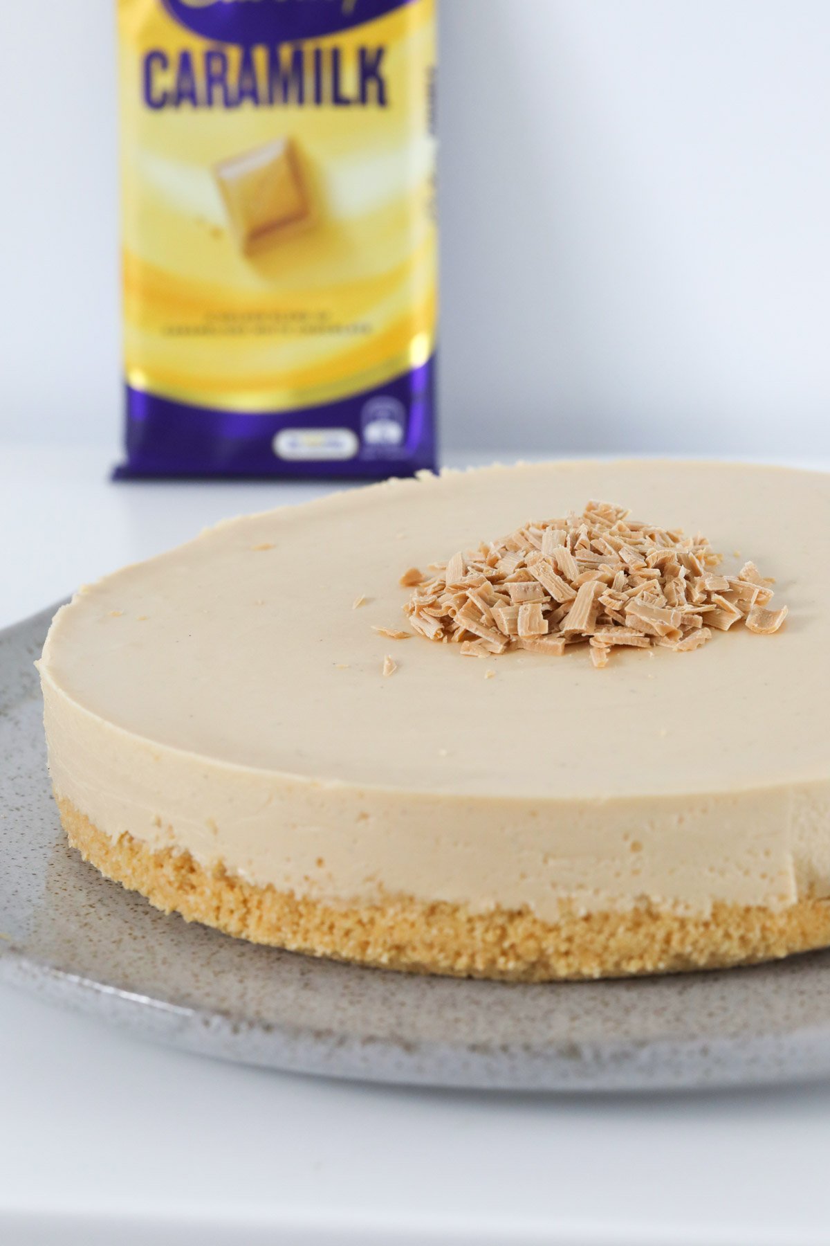 A Caramilk cheesecake with a block of chocolate in the background.
