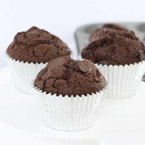3 double chocolate chip muffins in silver cases.