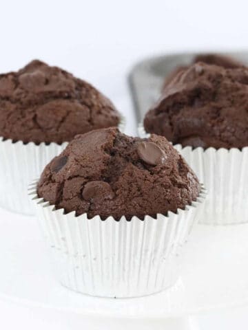 3 double chocolate chip muffins in silver cases.