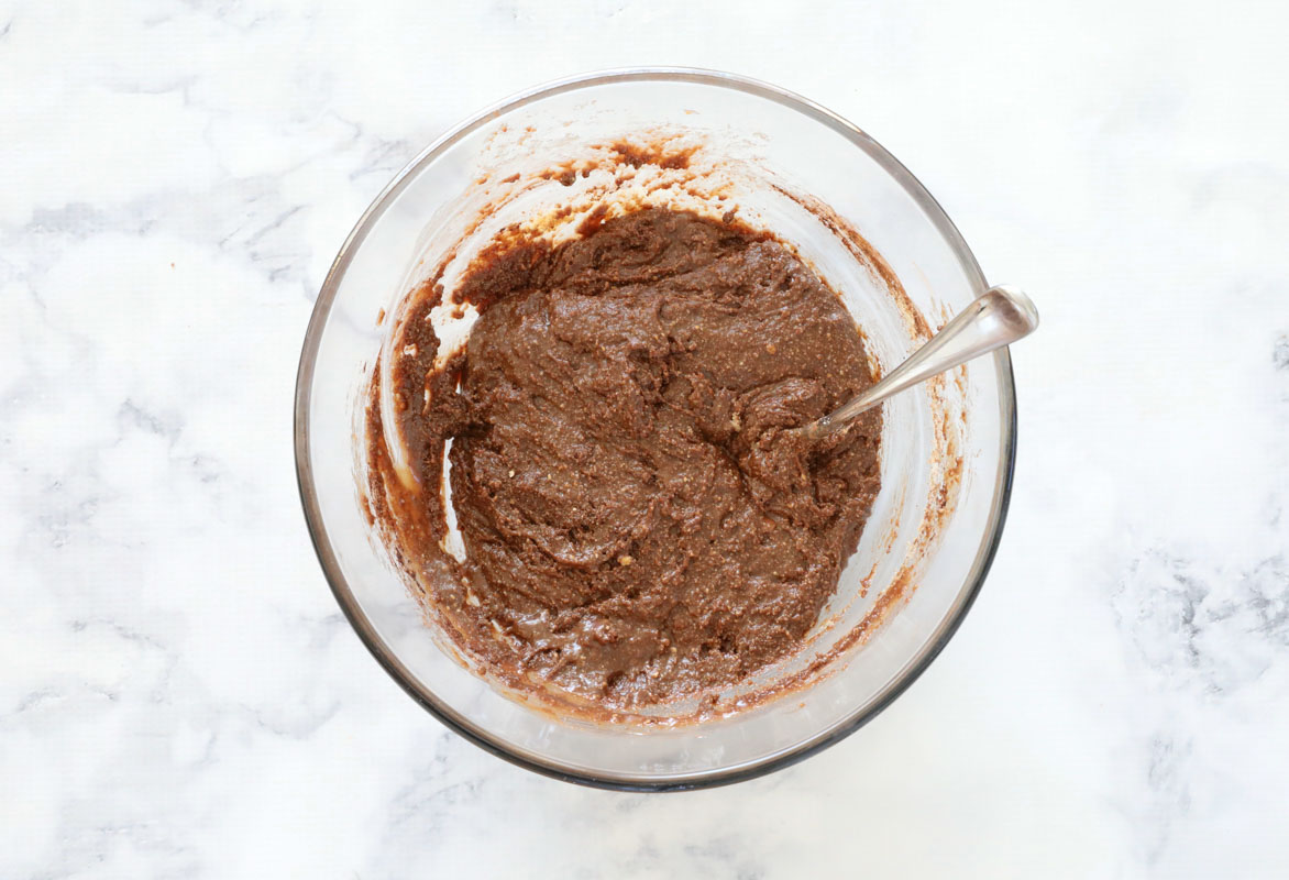 chocolate mixture combined in a glass bowl with a spoon