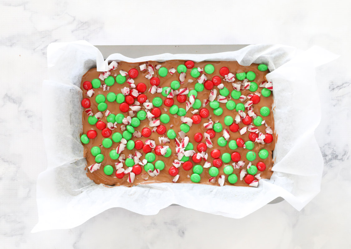Finished slice topped with crushed candy canes and red and green M&M's.