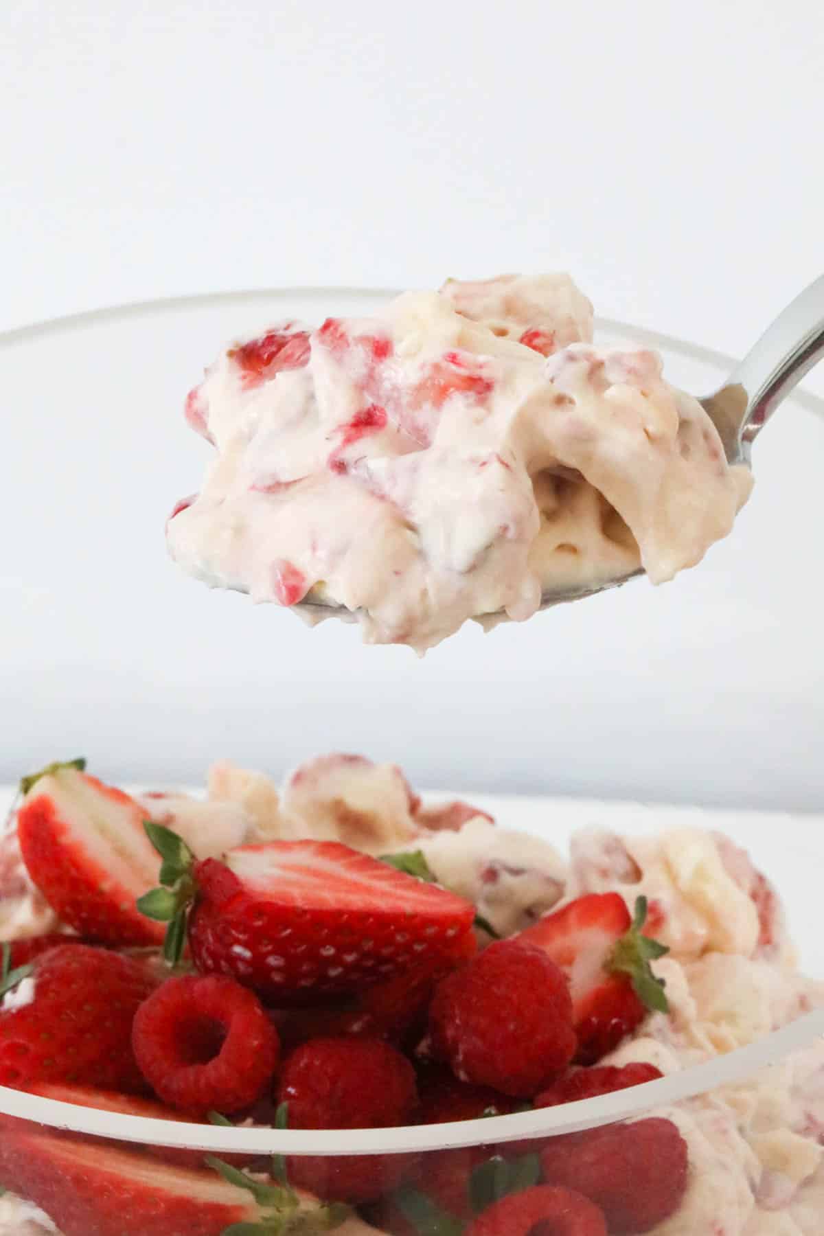 a spoon holding eton mess over a bowl