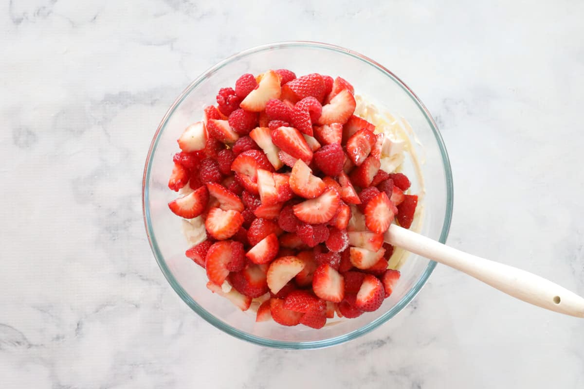 eton mess mixture and chopped strawberries in a bowl