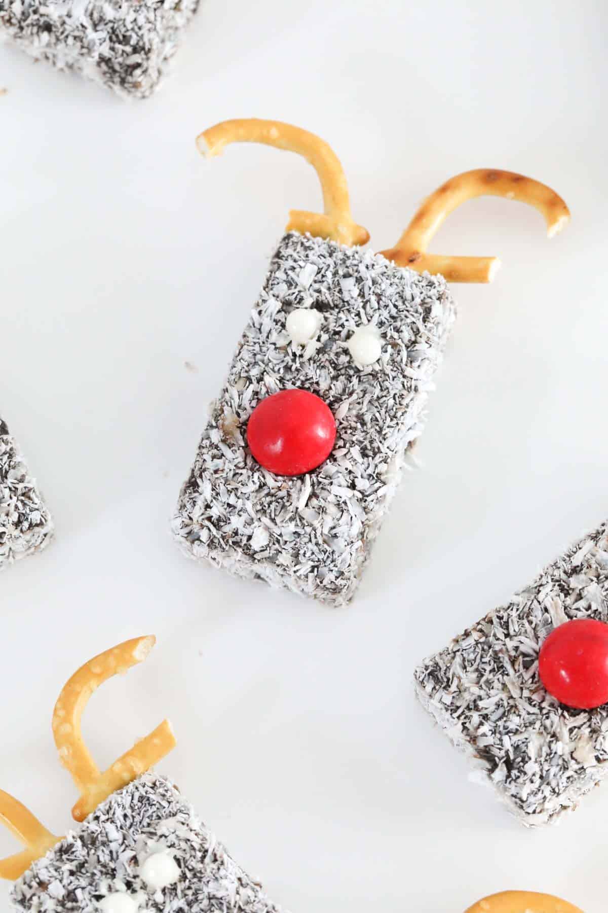 A chocolate coconut lamington finger decorated to look like a reindeer.