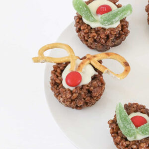 A white cake stand with Chocolate Christmas Crackles.
