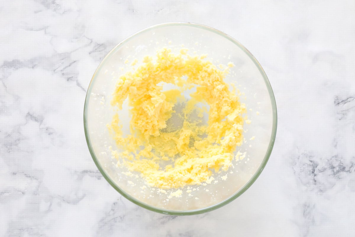 Butter and sugar creamed together in a glass mixing bowl
