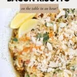 A pumpkin, spinach and bacon risotto with flaked almonds sprinkled over the top, and lemon wedges on the side.