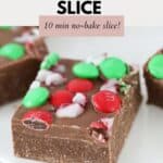 A piece of chocolate slice decorated with crumbled candy canes and red and green M&M's.