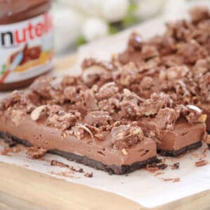 Pieces of Nutella cheesecake on a chopping board.