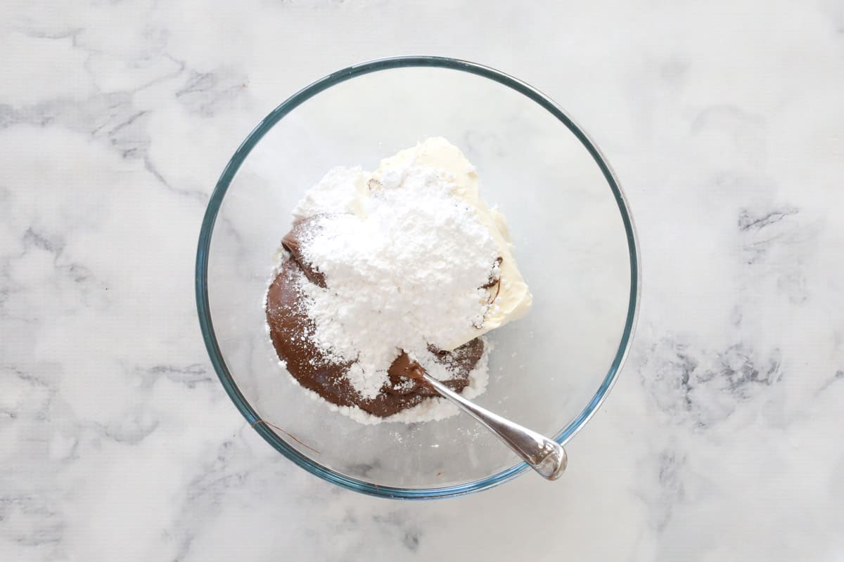 Nutella, cream cheese and icing sugar in a bowl