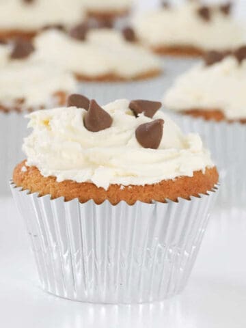 A chocolate chip cupcake with buttercream frosting.