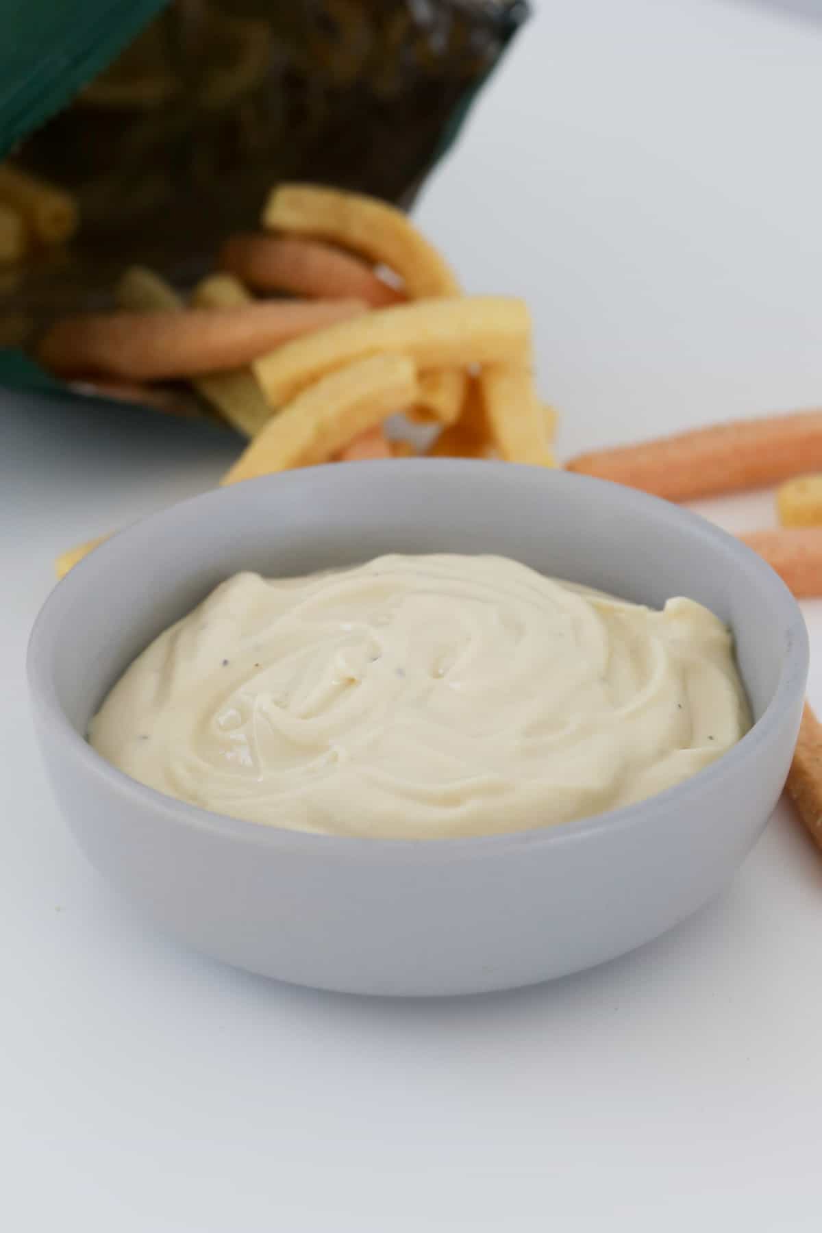 Creamy sauce in a small grey bowl.