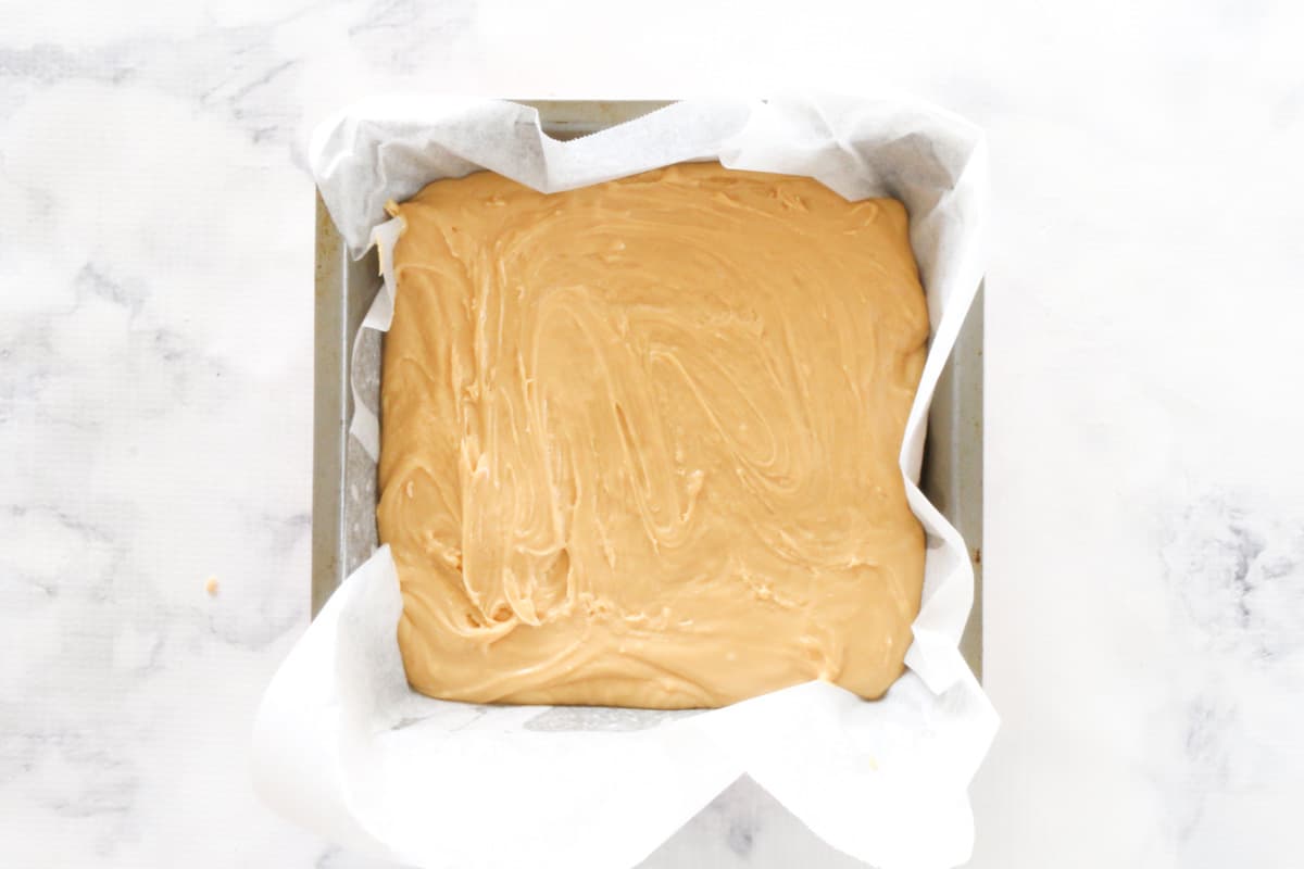 Top view of 2 ingredient fudge in a lined cake tin