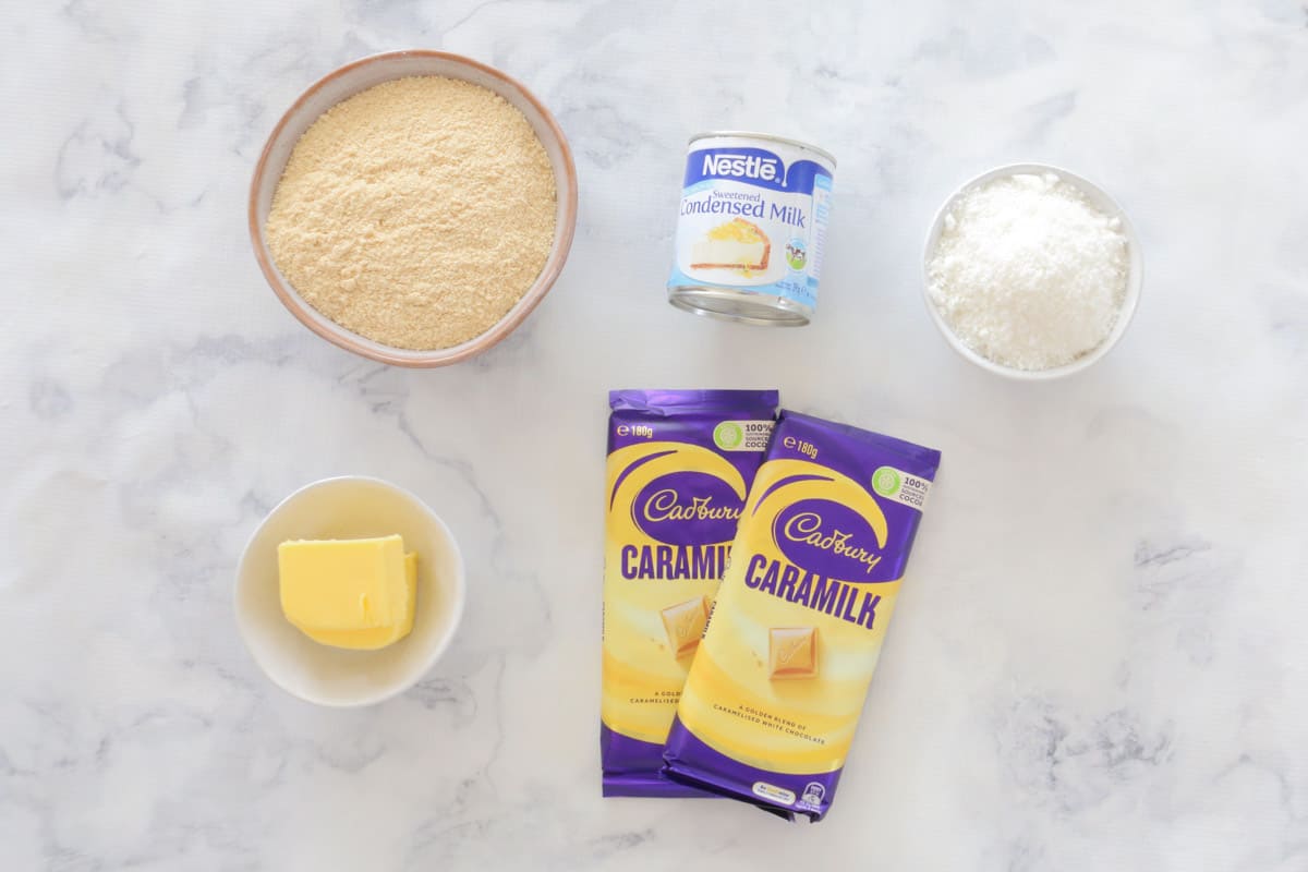 All ingredients for Caramilk slice laid out on a marble bench top.