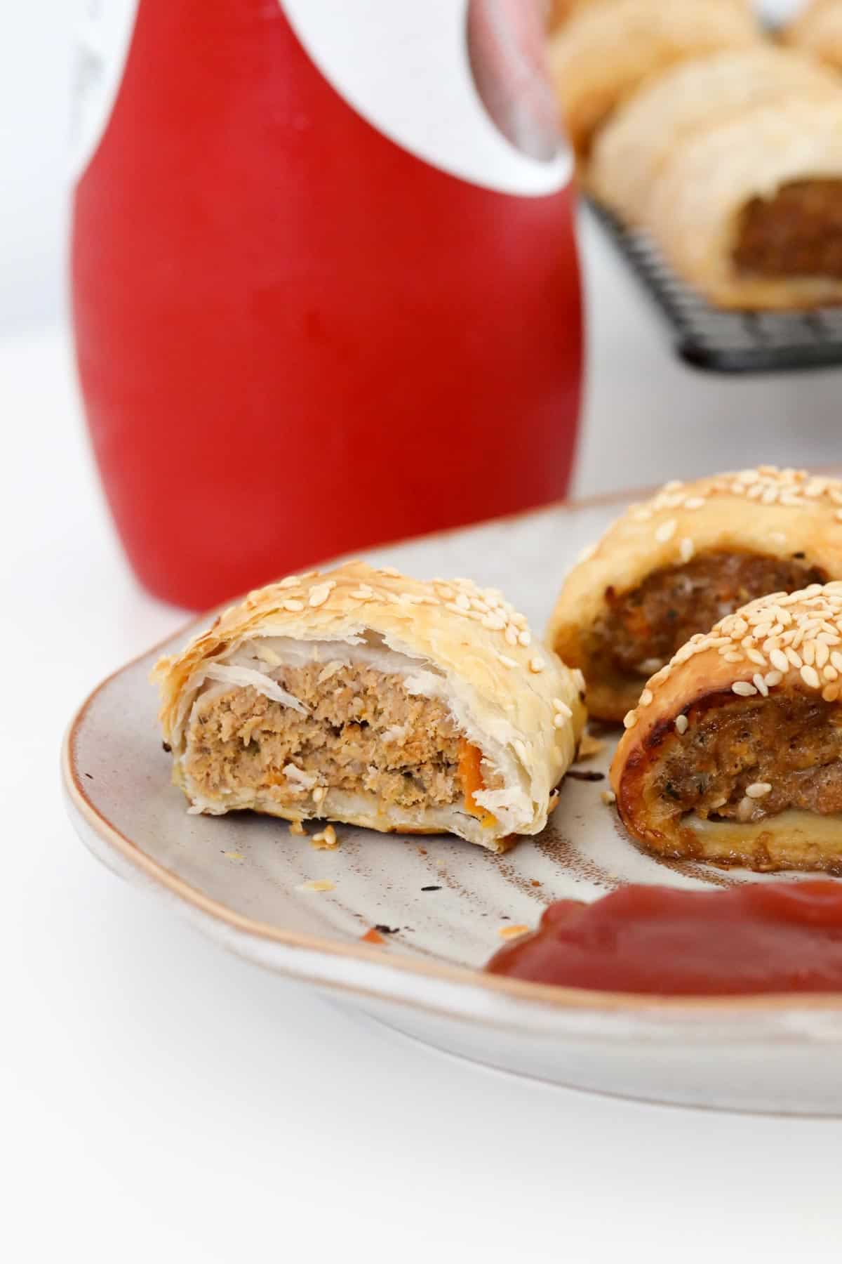 Beef pastry rolls on a plate with tomato sauce