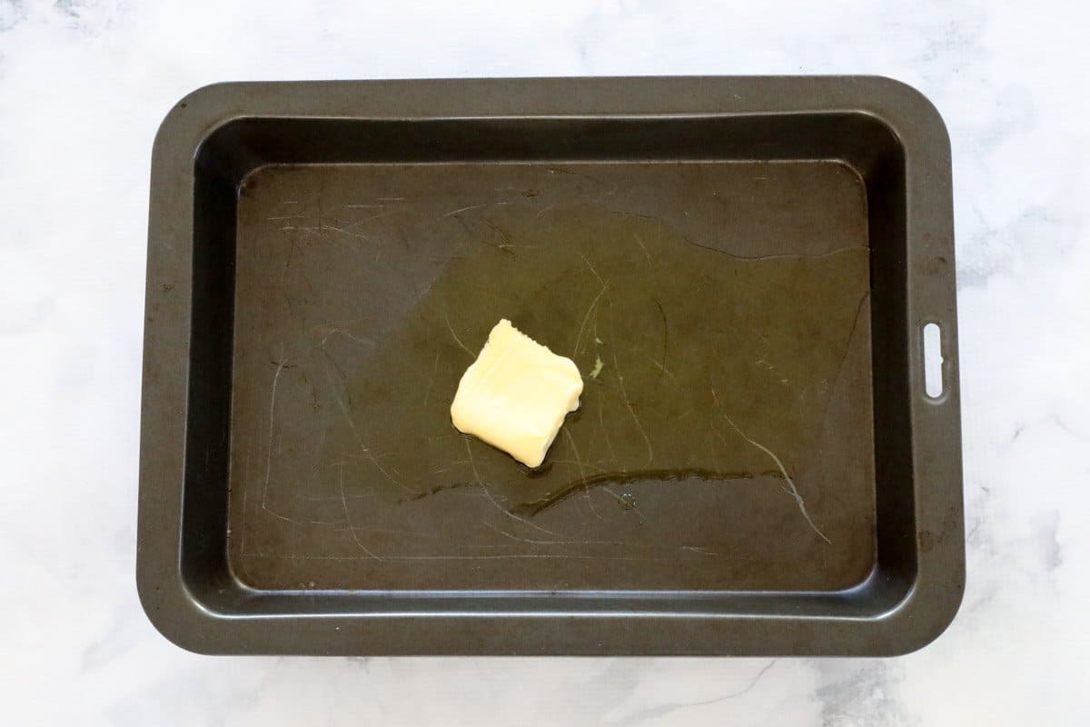 Butter and oil in a oven pan.