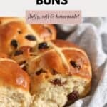 A batch of fruity Hot Cross Buns resting in a tea towel.