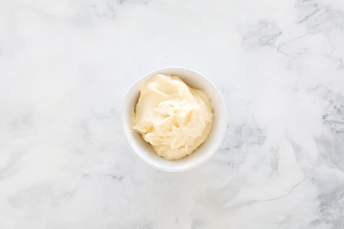 Vanilla buttercream filling in a small white ramekin