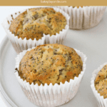 White muffin cases filled with golden baked orange & poppyseed muffins