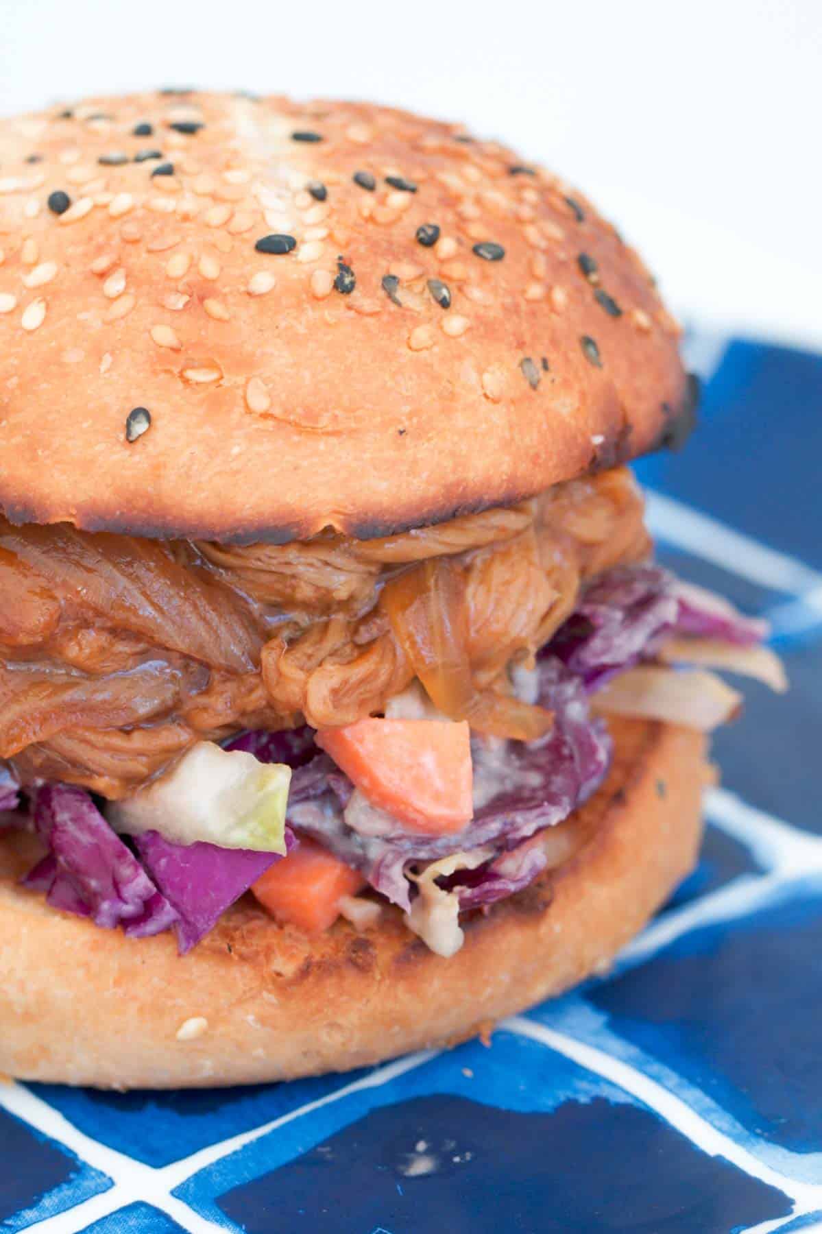 Slaw and pork with a bbq sauce in a burger bun.