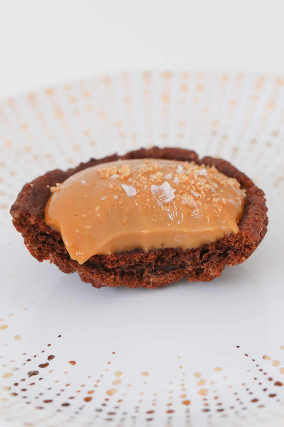A half-eaten chocolate biscuit with a sweet caramel filling and salt.