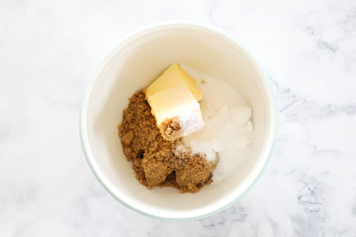 Butter, caster sugar and brown sugar in a bowl.
