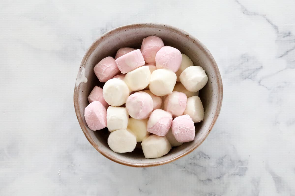 A bowl of pink and white marshmallows